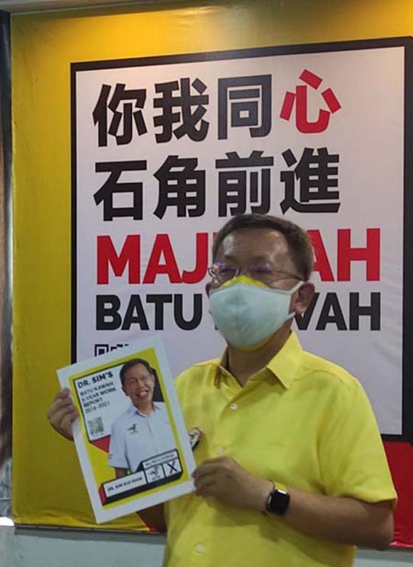 石角区候选人拿督斯里沈桂贤展示其5年来的服务成绩单时摄。