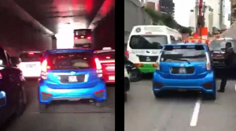 轿车在繁忘车道内“硬挤”，路人阻止不遂。